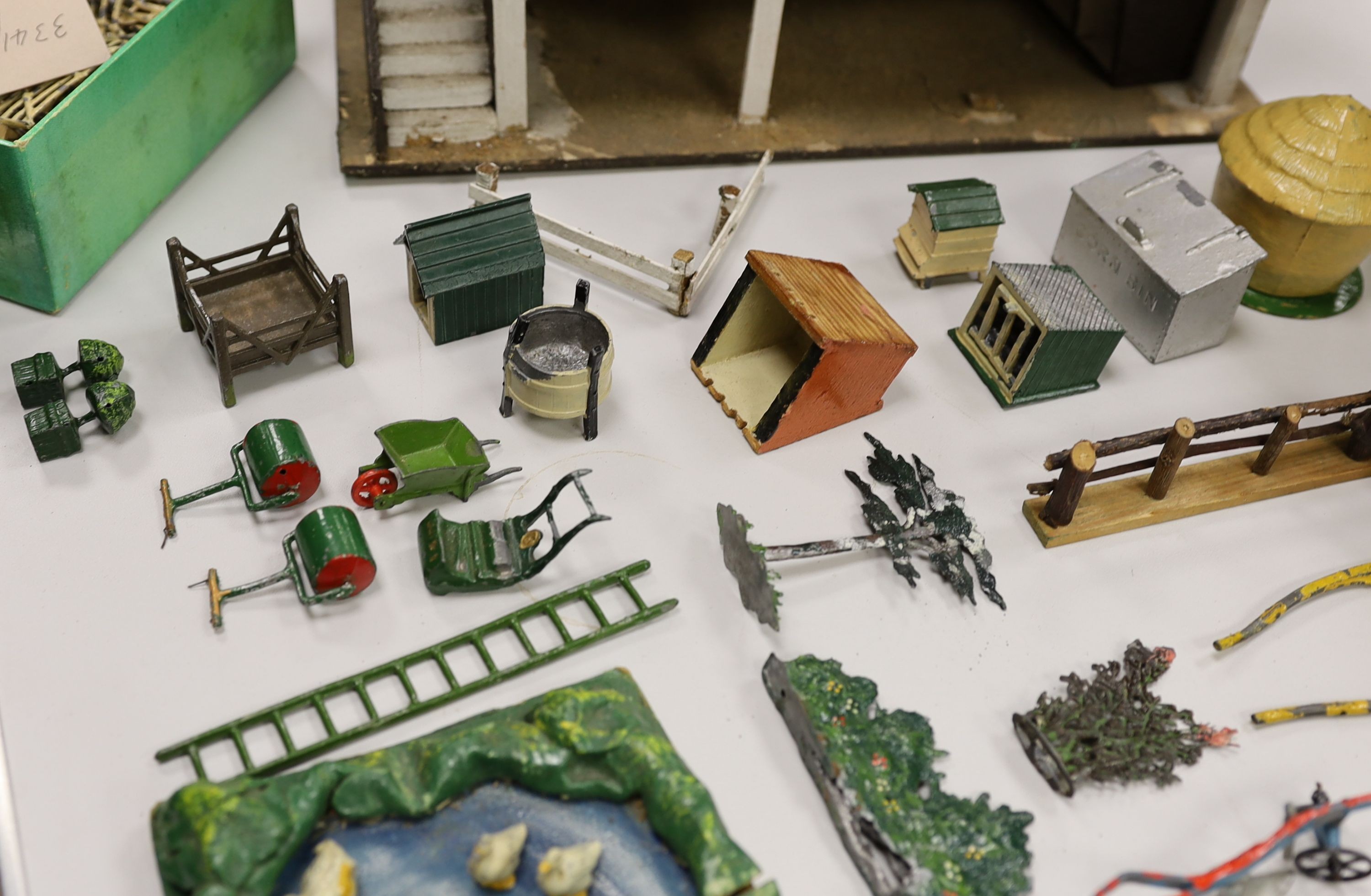 A collection of mainly Britains painted lead figures and animals, including huntsmen and hounds, farm workers, animals and wooden buildings